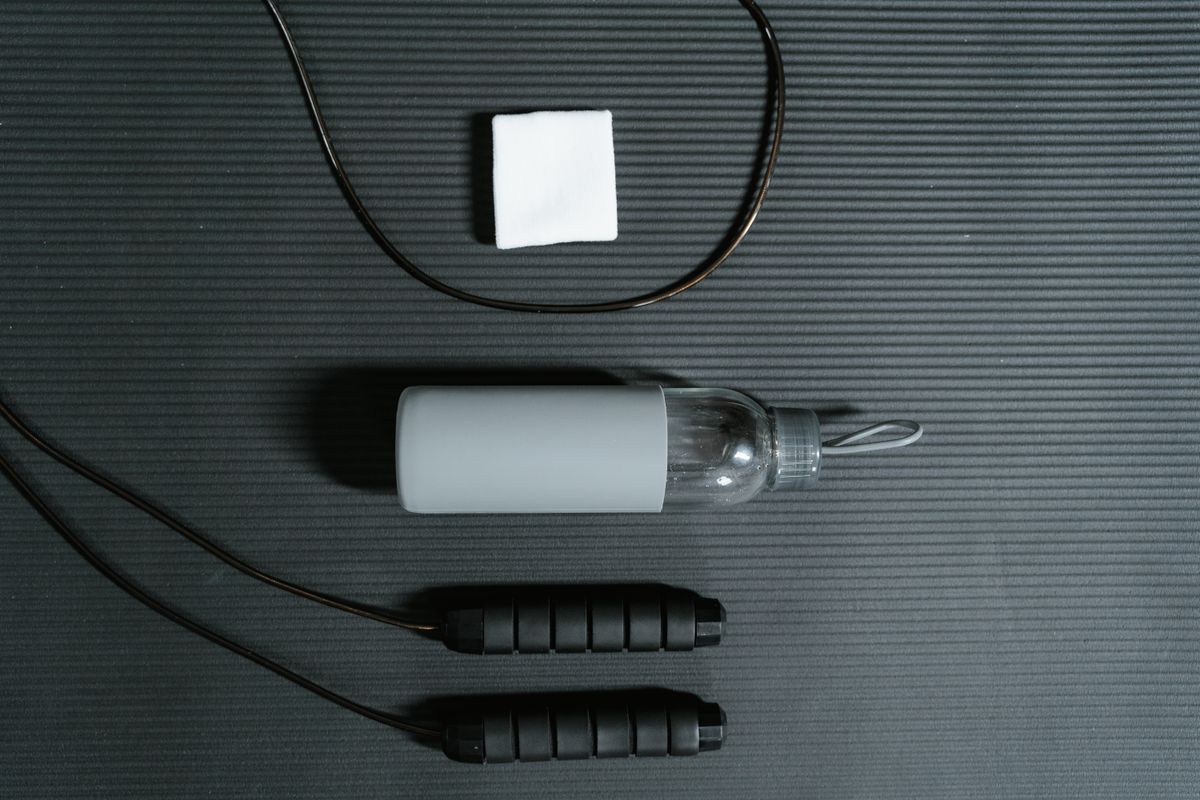 Workout gear with jewellery taken off — water bottle, towel, and a protective pouch.