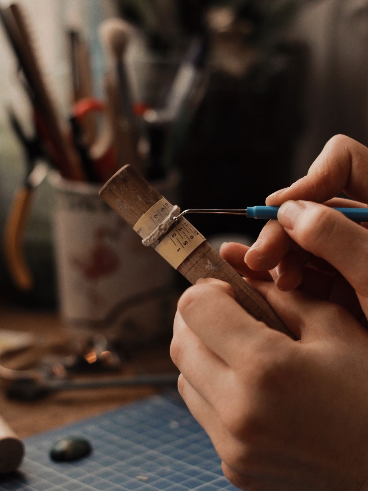 A jeweller crafting fine metal — 18K gold plating over a premium 925 sterling silver base.