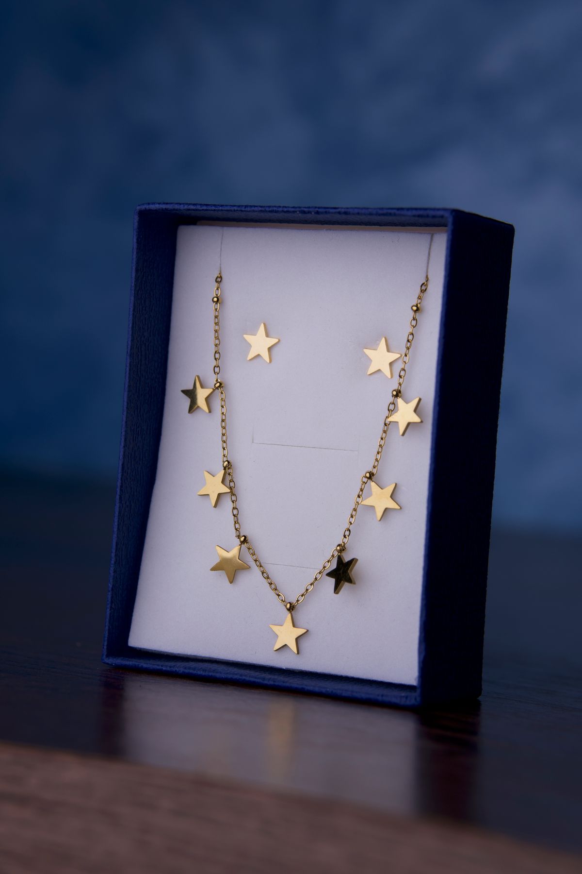 A gold pendant engraved with a tiny star motif, symbolizing personal goals and intentions.