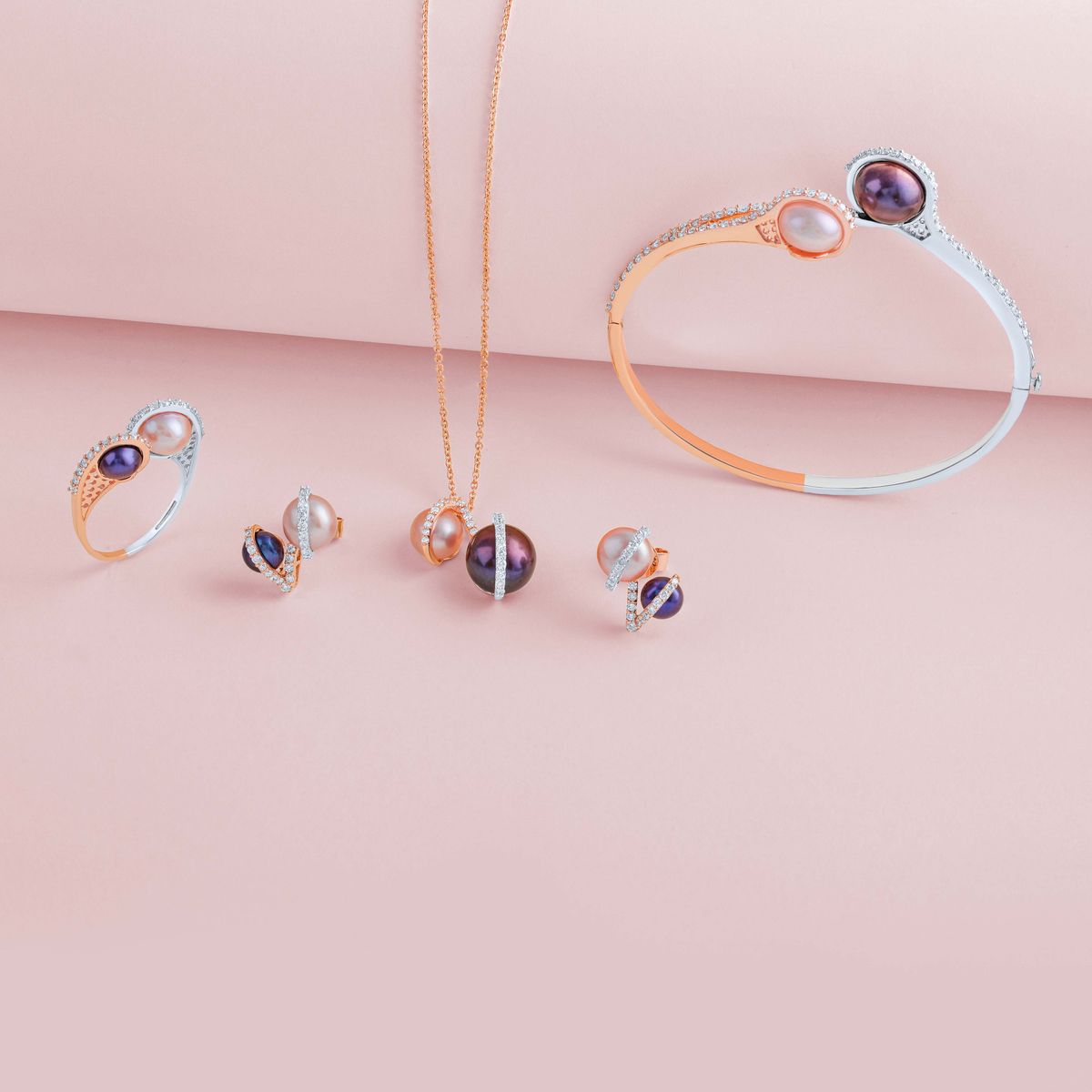 A pastel pink outfit paired with delicate silver and rose gold pieces.