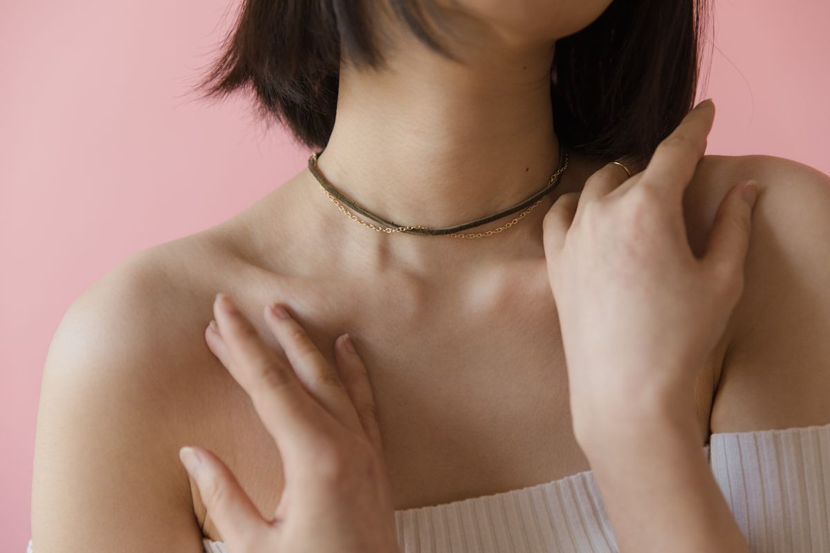 Let a thin gold choker peak out from beneath the open collar of an oversized button-down shirt.