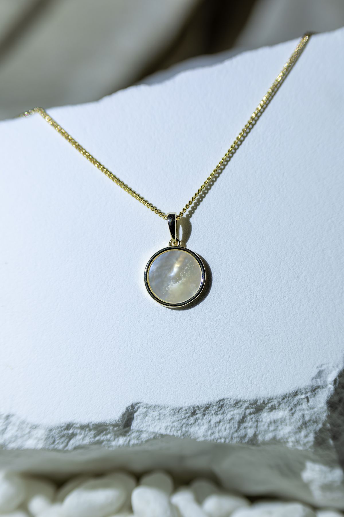 A personalized initial pendant honors her unique journey and individual identity.