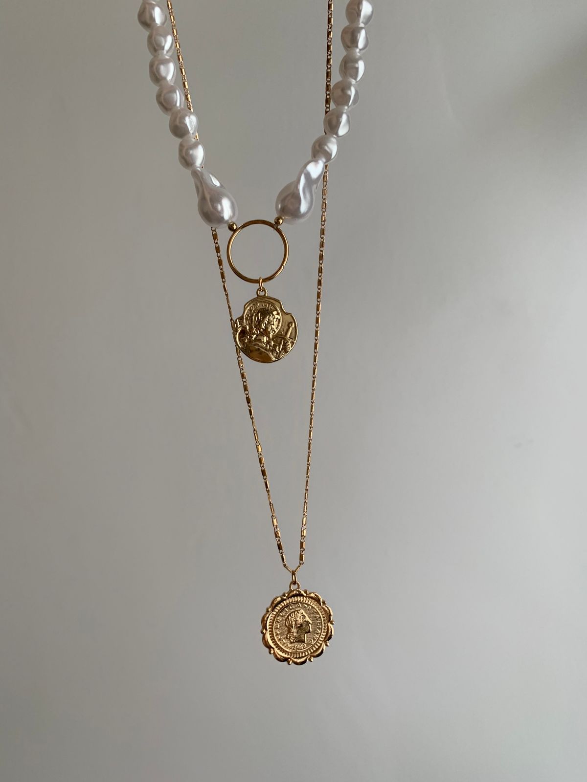Layer three different chains — choker, cuban link, and pendant — for harmonious density.