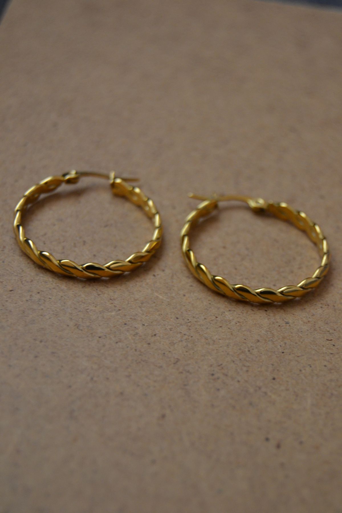 Low-profile huggie hoops offer a clean, pulled-together frame for your face on every camera angle.