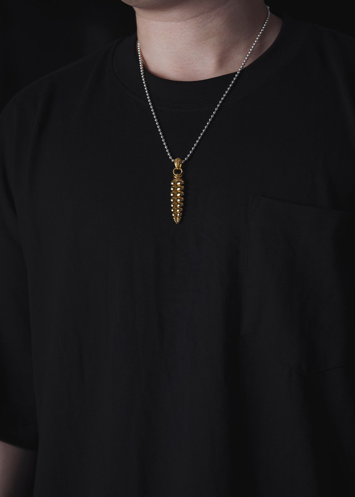 Layer a chunky gold chain over a plain crewneck tee for an off-duty model aesthetic.