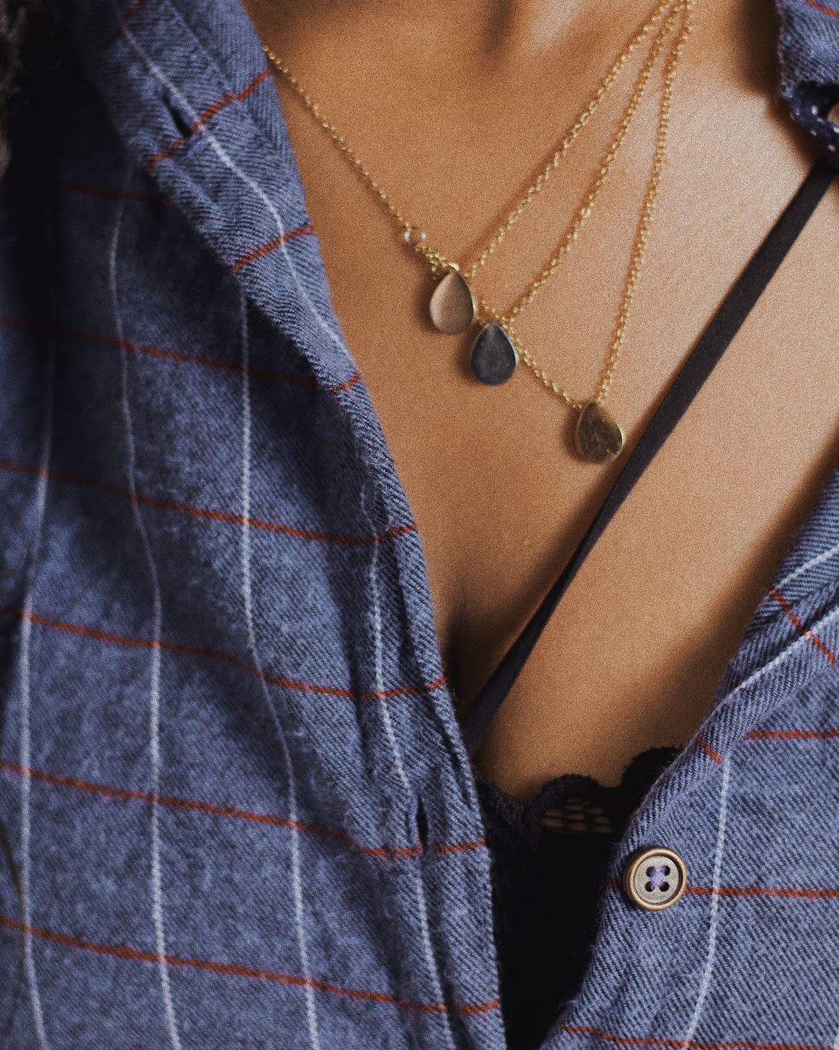 A chunky chain inside an open collar — exposed skin creates natural negative space.