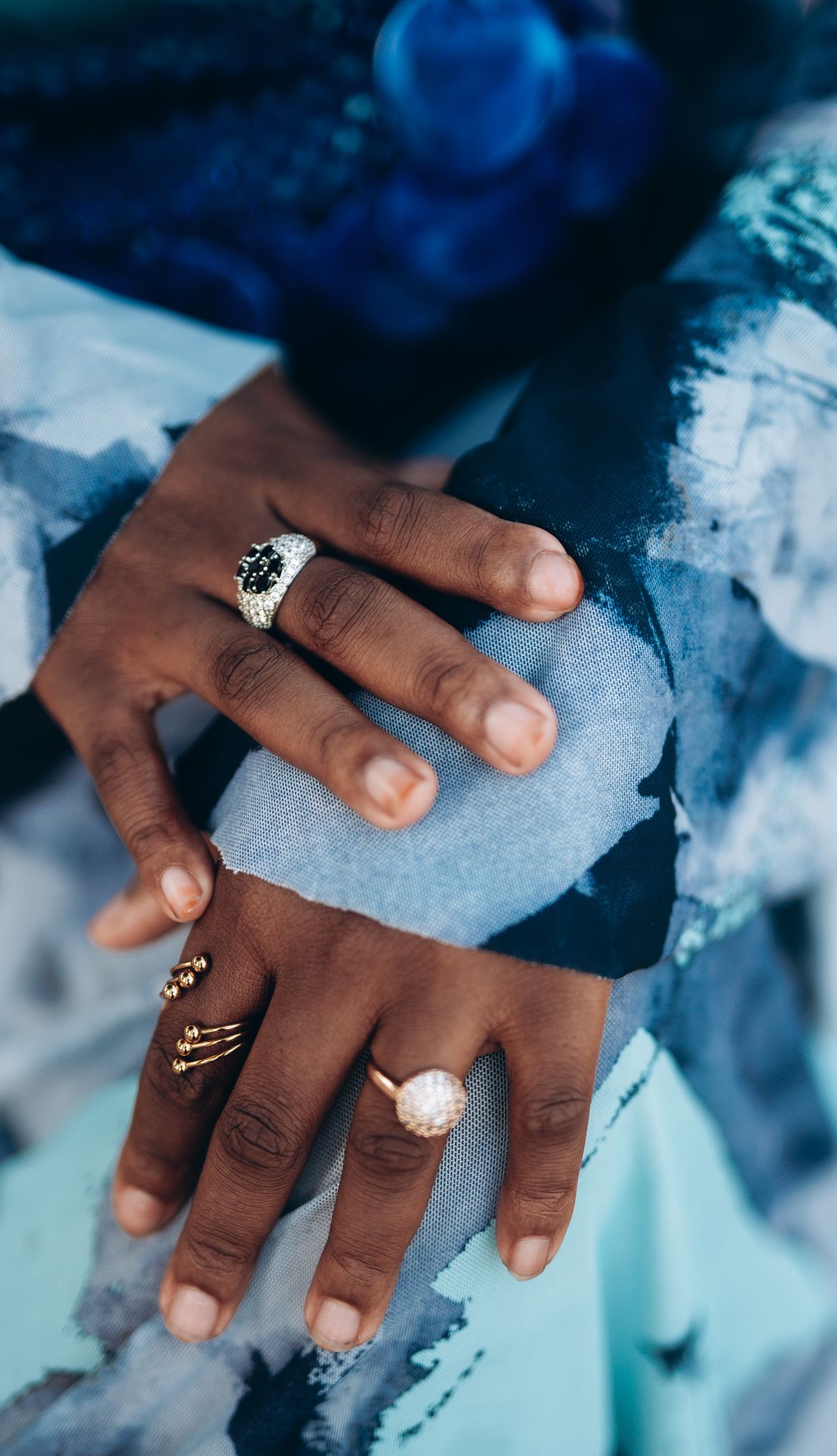 Concentrate the colour on your hands — a ring stack becomes a contiguous block of warmth.